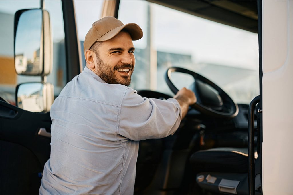A driver entering a truck parking with a truck.