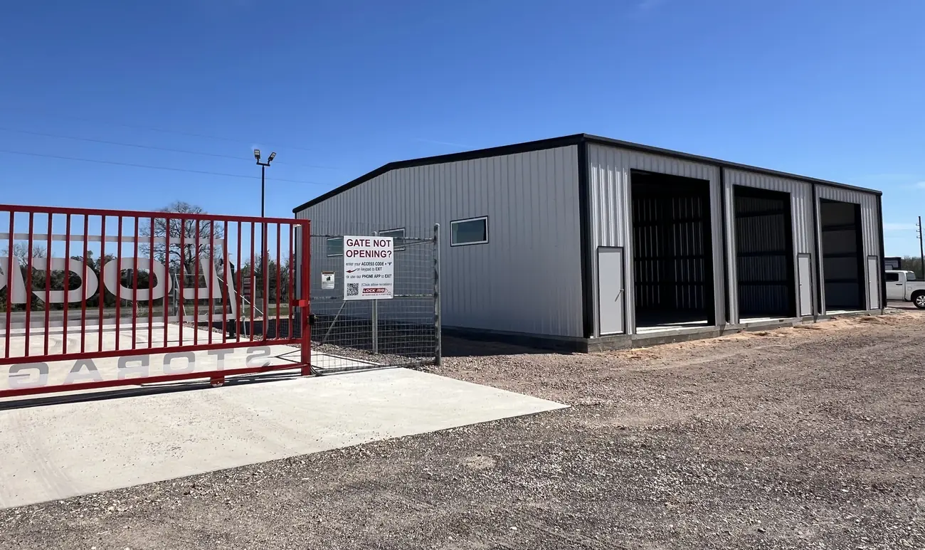 The controlled-access gate at LockRig with truck bays visible behind it