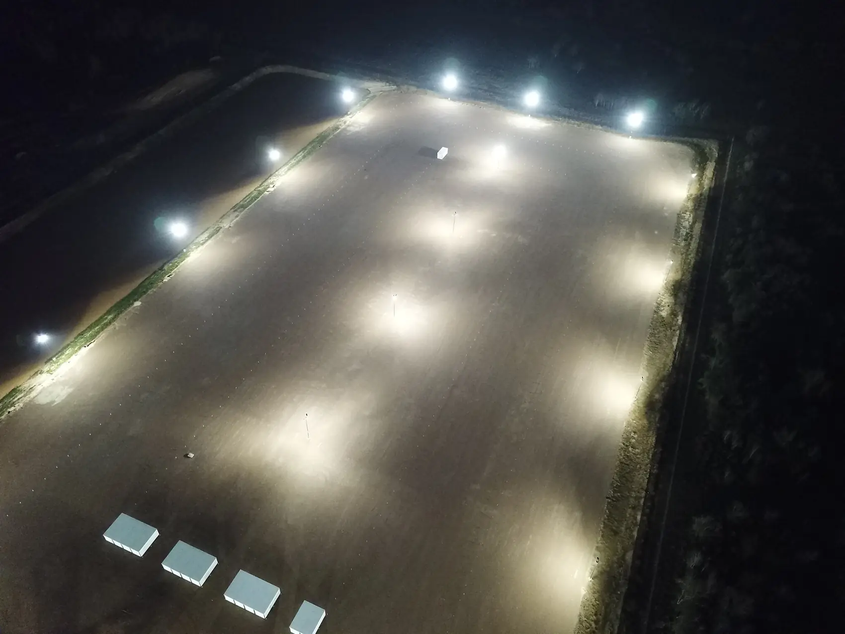 The LockRig yard at night, lit end to end, where the storage vaults sit behind the same gate as the truck parking